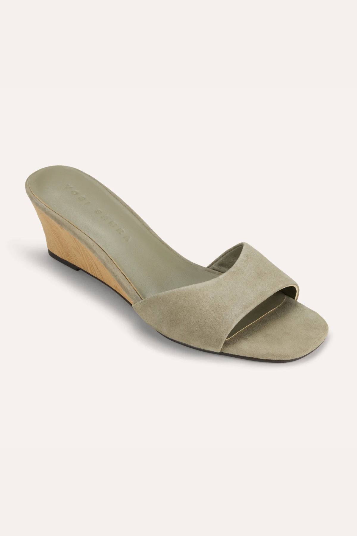 Green sandal with a wedge heel on a white background