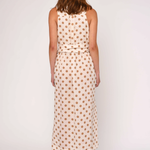 Woman wearing a polka dot dress on a white background