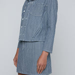 Cropped structured jacket in a muted blue tone.