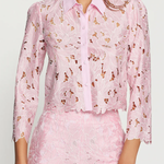 Woman wearing a pink floral outfit on a white background