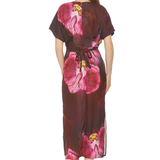 back of woman in floral printed dress on white background 