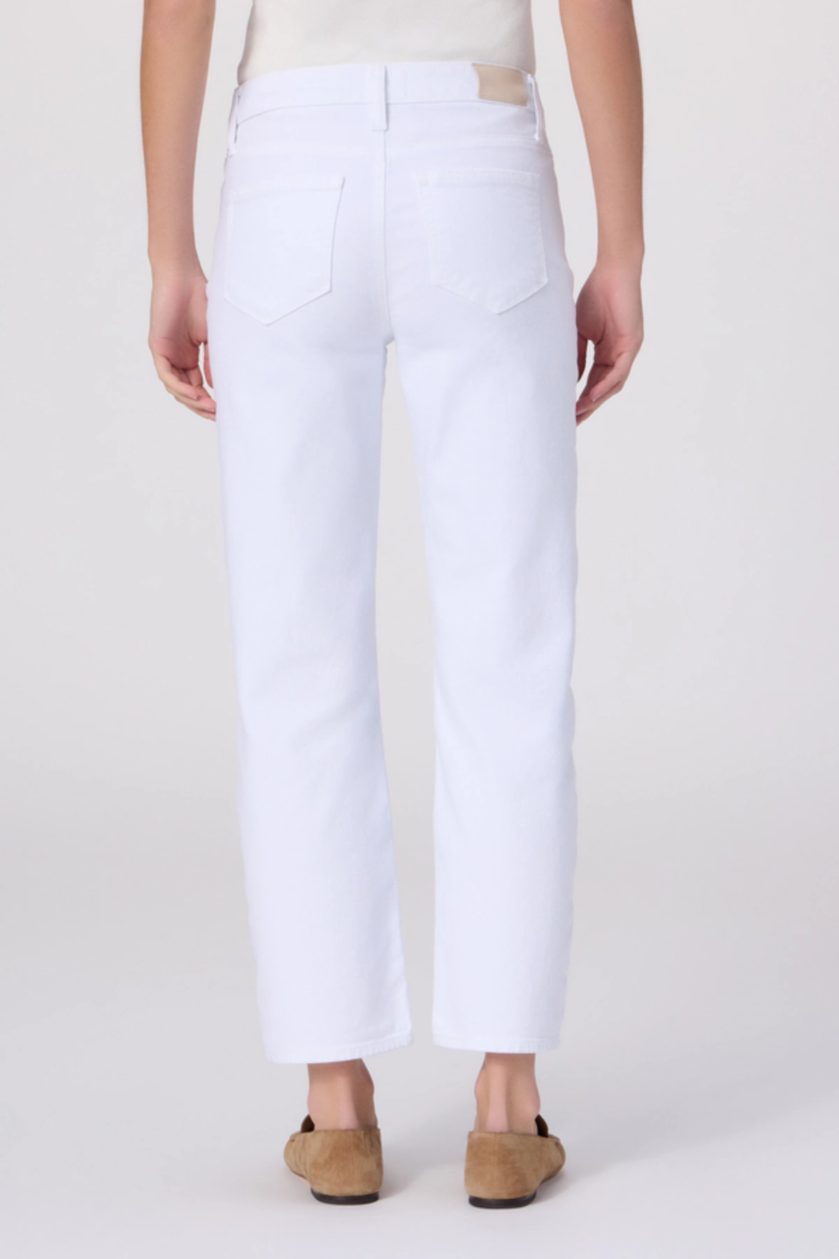 White pants worn by a person on a white background