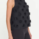 Black sleeveless top with floral embellishments on a white background