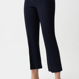 Navy blue pants worn by a person on a white background
