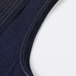 Close-up of a navy blue garment with gold stitching on a white background