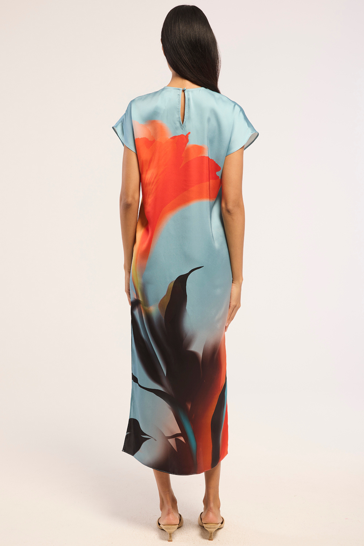 Model wearing a colorful printed sleeveless midi dress.