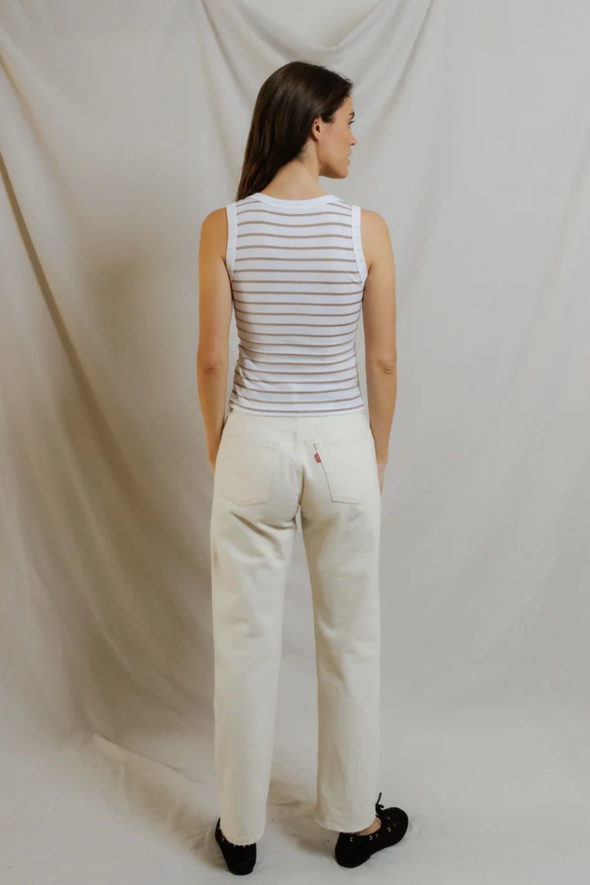 back of woman in stripe top and denim 
