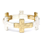 Gold and silver cross-shaped ring on a white background