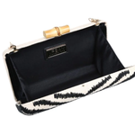 Black clutch with white interior and gold accents on a white background
