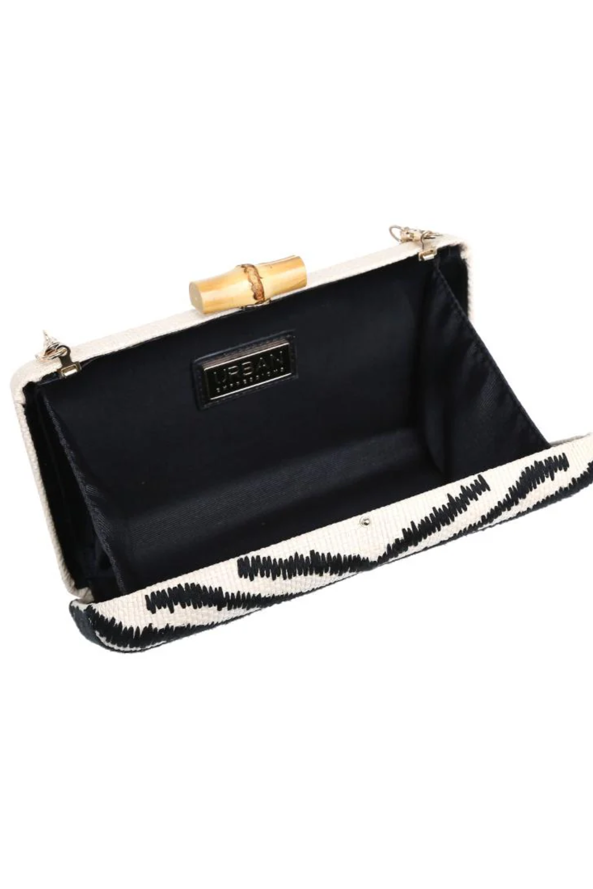 Black clutch with white interior and gold accents on a white background
