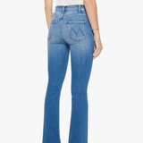 back of woman in blue denim and white tank top on white background 