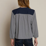 Neutral long-sleeve top styled casually with denim