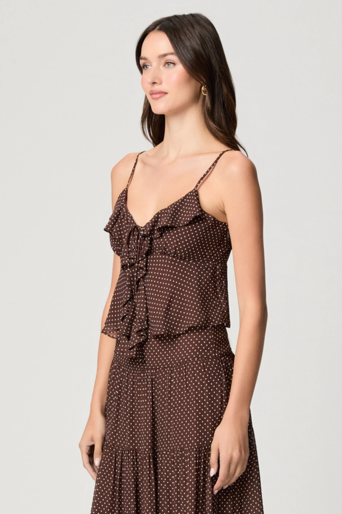 Model wearing a mahogany and ecru color-block camisole with adjustable straps.