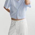 blue striped button up top worn by model against a white background