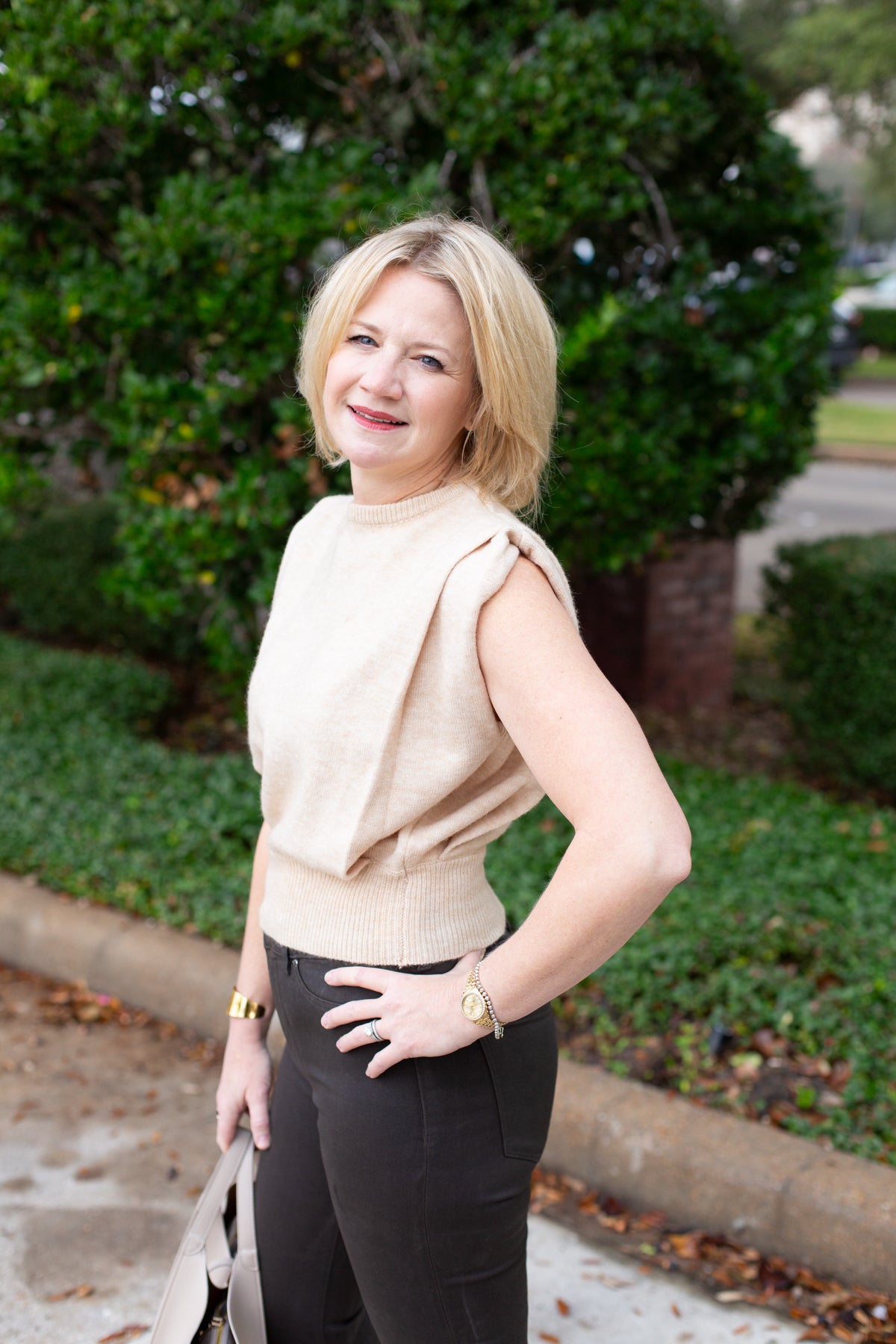 Sleeveless knit muscle sweater vest styled with trousers