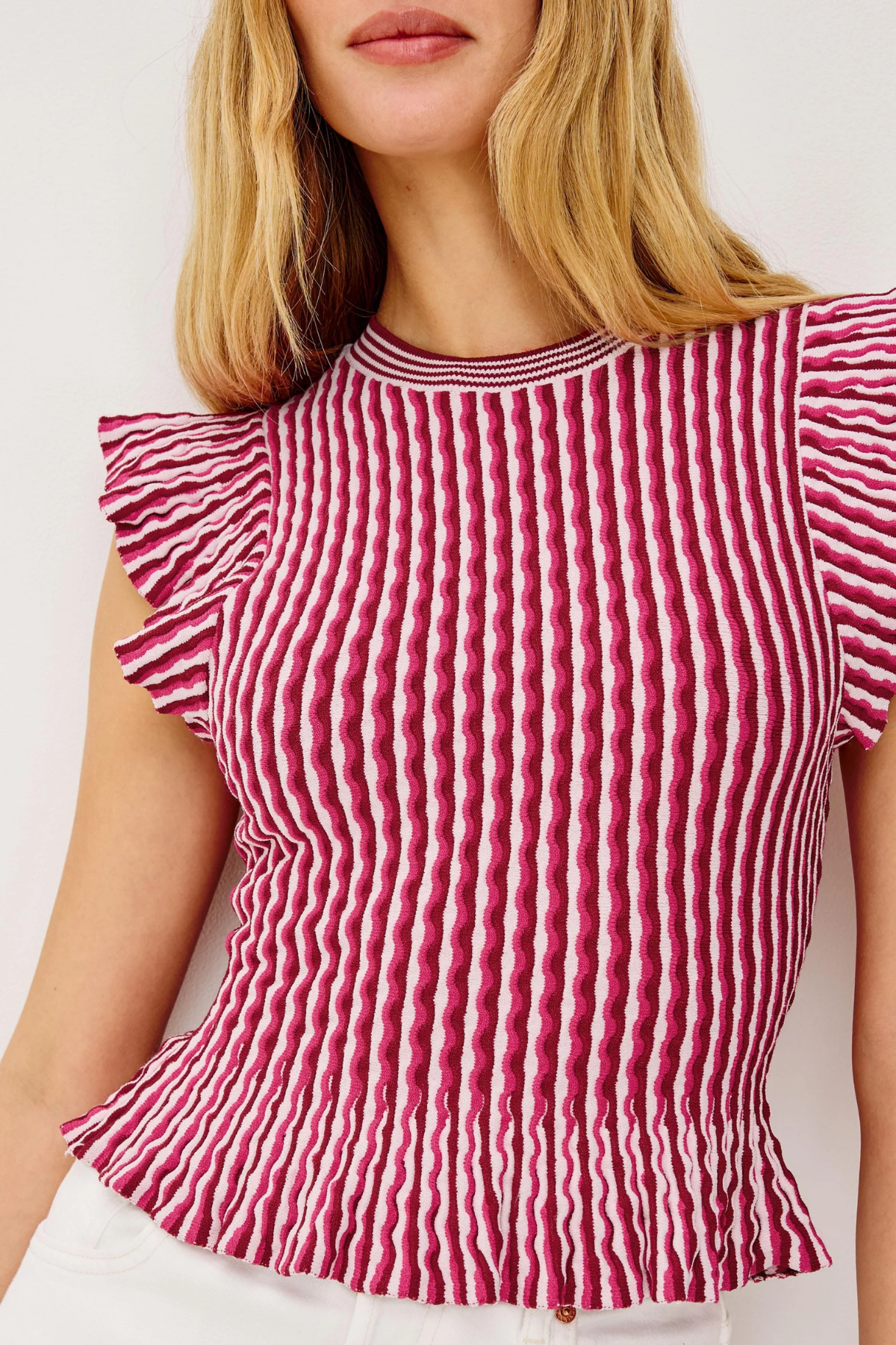 Red and white striped top with ruffled sleeves on a plain background