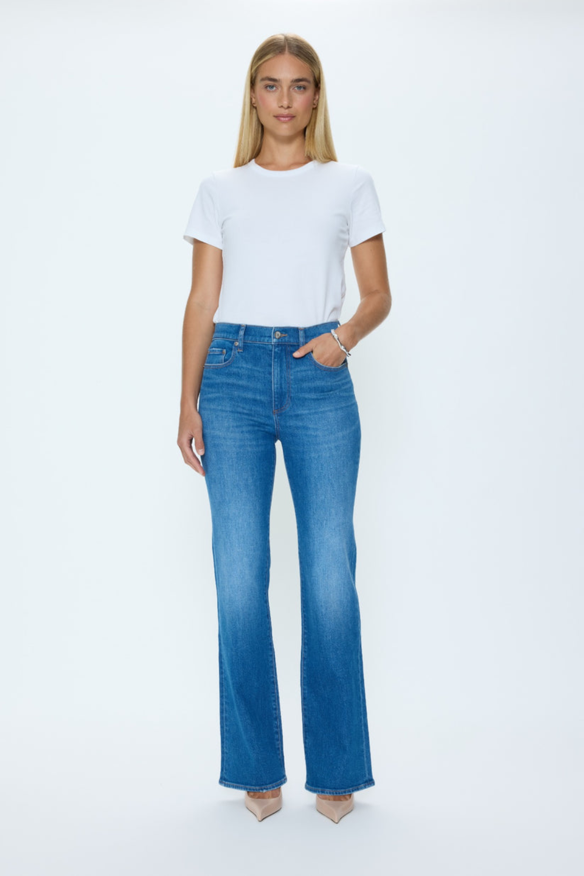 Woman wearing a white t-shirt and blue jeans on a white background