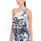 Woman wearing a one-shoulder dress with a blue and white pattern on a white background