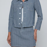 Cropped structured jacket in a muted blue tone.