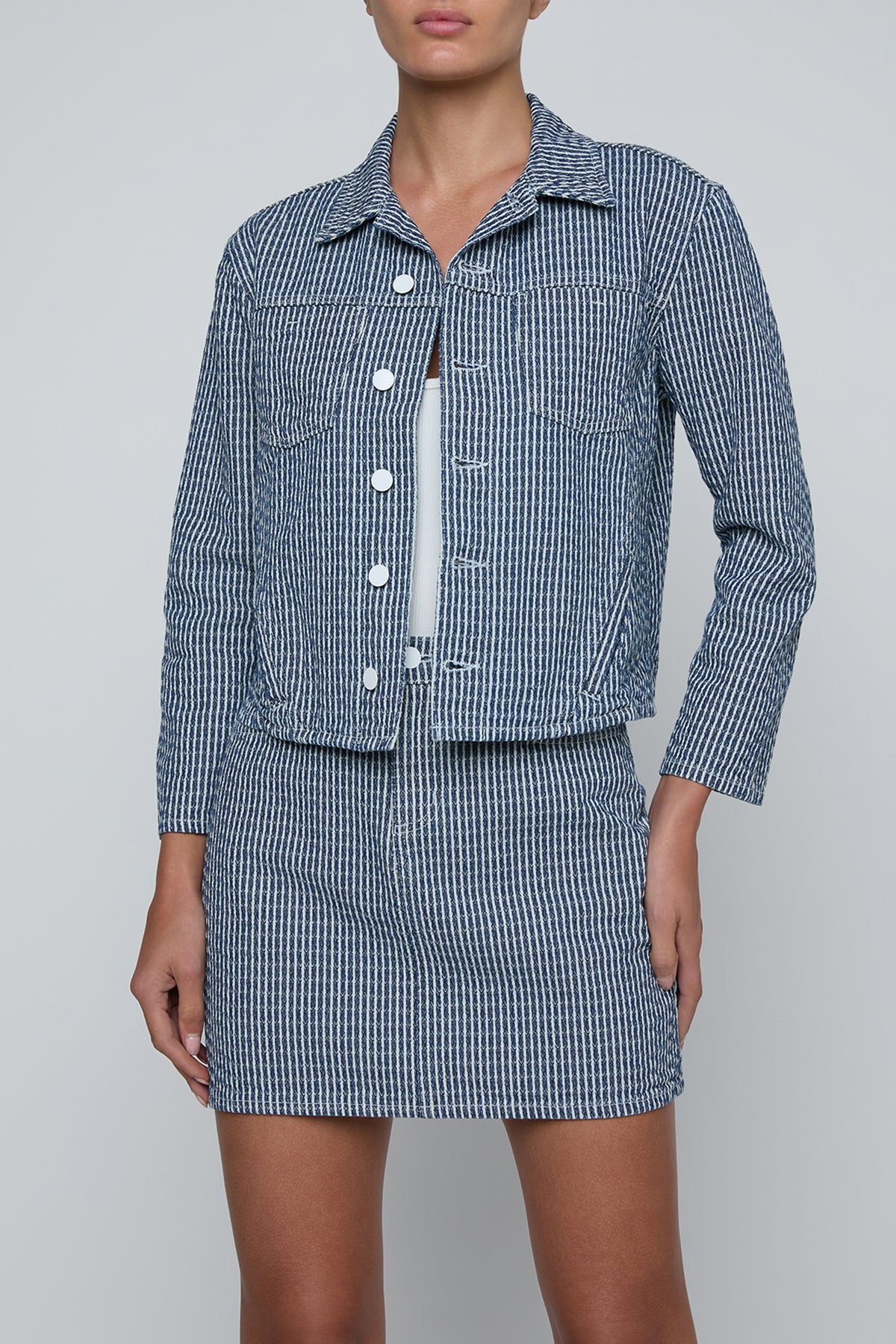 Cropped structured jacket in a muted blue tone.