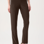 Model wearing slim-fit tailored pants with a streamlined ankle-length silhouette in a classic solid color.