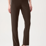 Model wearing slim-fit tailored pants with a streamlined ankle-length silhouette in a classic solid color.