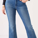 A person wearing medium-wash blue flare jeans with a black belt and gold buckle, paired with a black blouse, shown from the waist down against a plain light background.