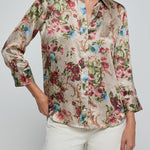 Woman wearing a floral blouse with a plain background