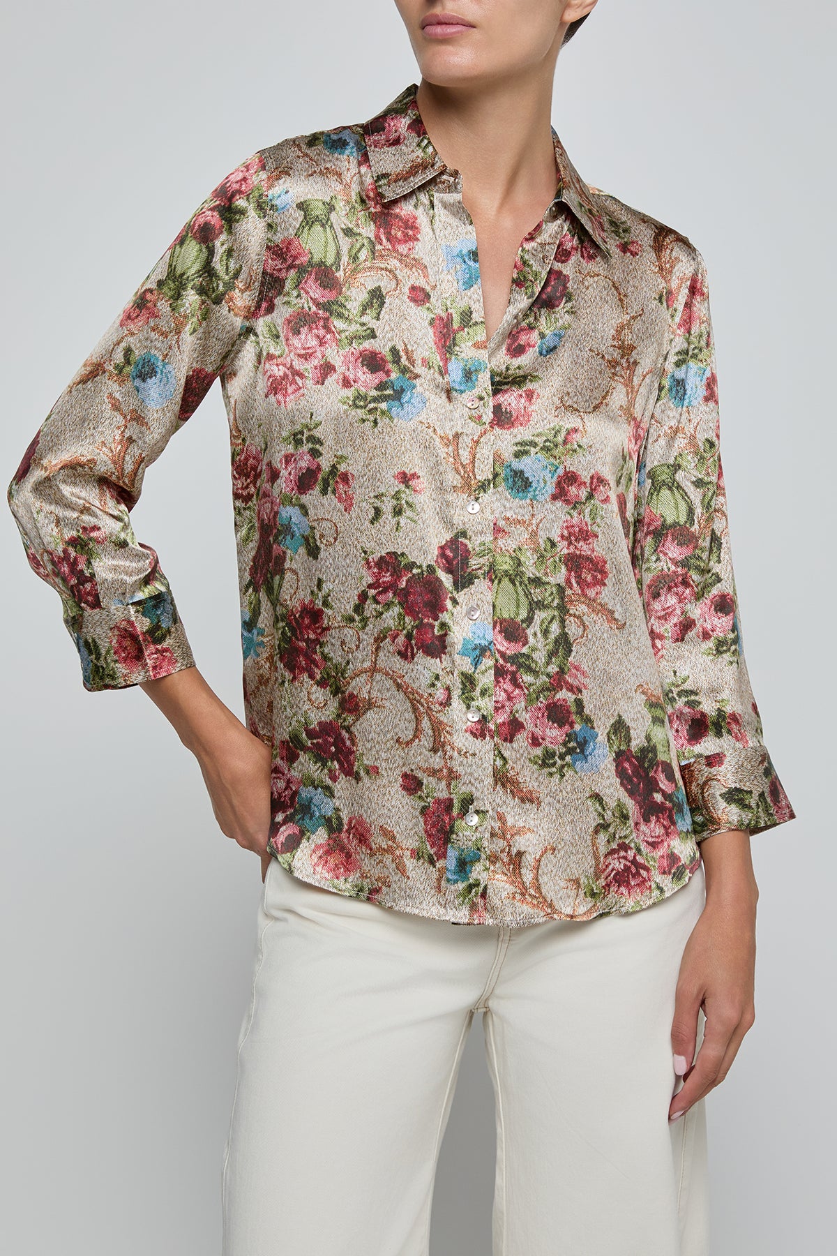Woman wearing a floral blouse with a plain background