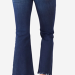 A person wearing dark blue flare jeans with frayed hems and tan flat sandals, shown from the back against a light gray background.