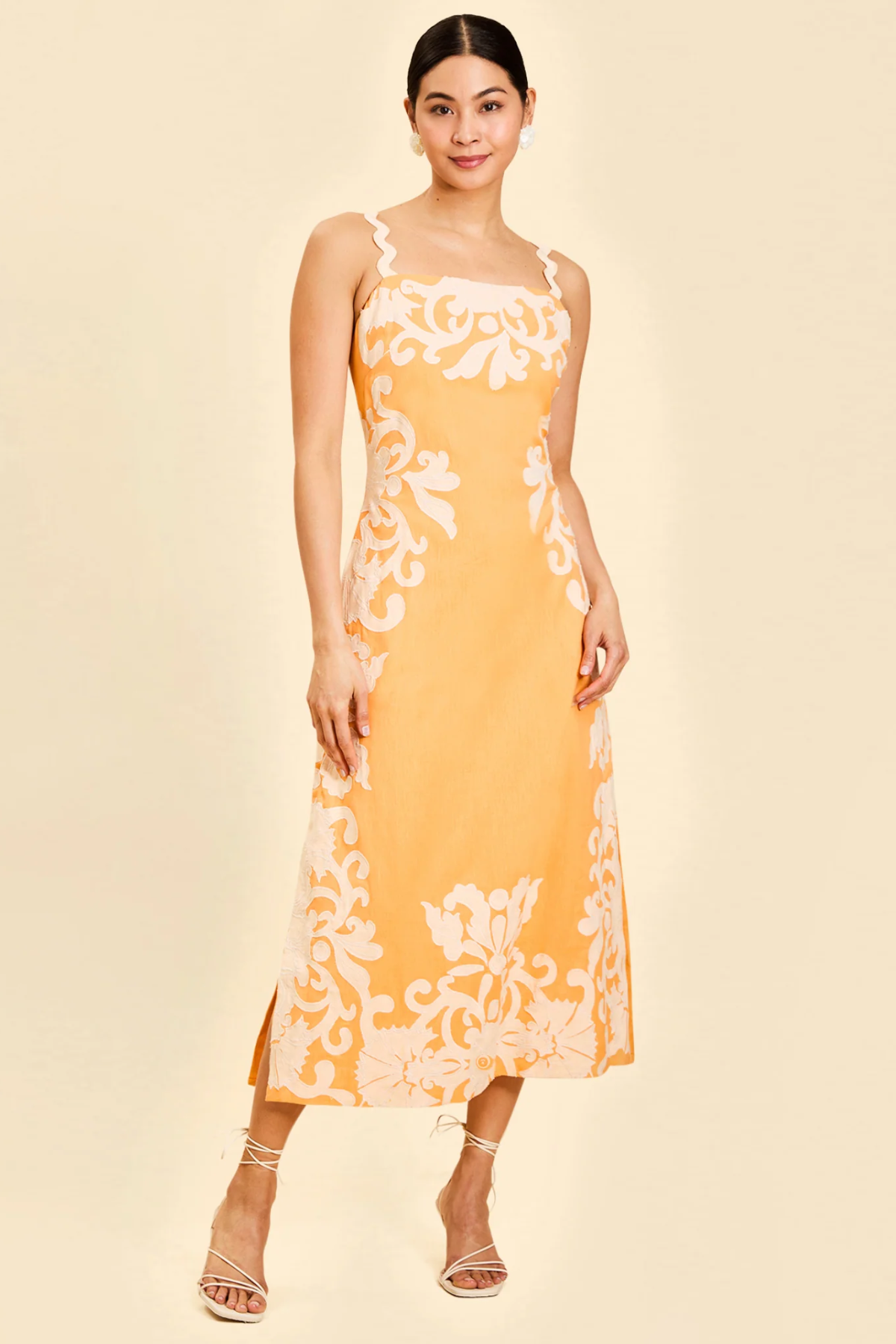 woman in orange embroidered midi dress 