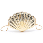 Gold shell-shaped clutch bag on a white background