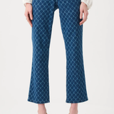 Blue patterned jeans worn by a person on a white background