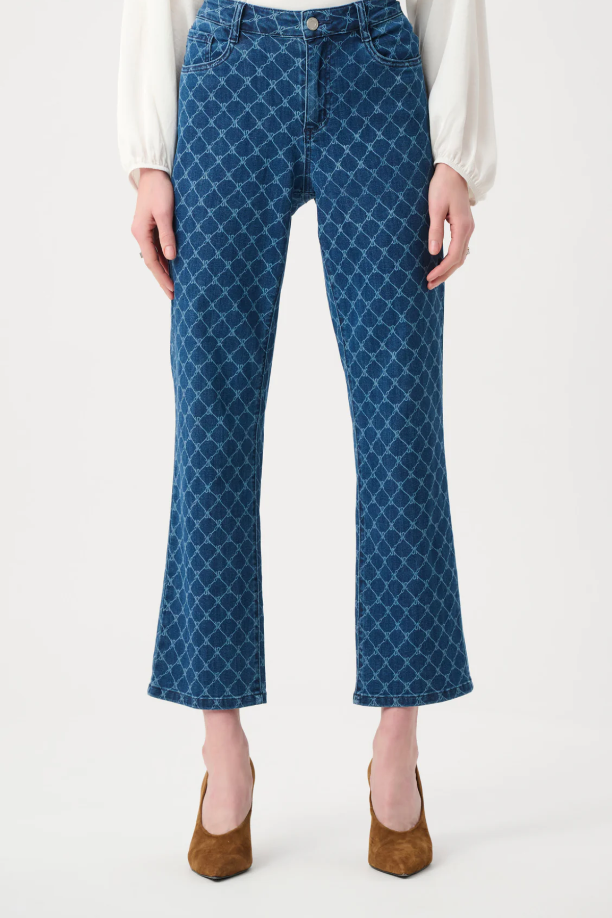 Blue patterned jeans worn by a person on a white background