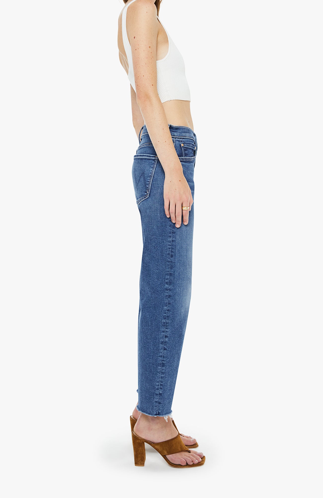 Person wearing blue jeans and a white top on a white background