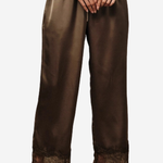 A person wearing wide-leg brown satin pants with a lace hem, paired with black pointed shoes against a plain light gray background.
