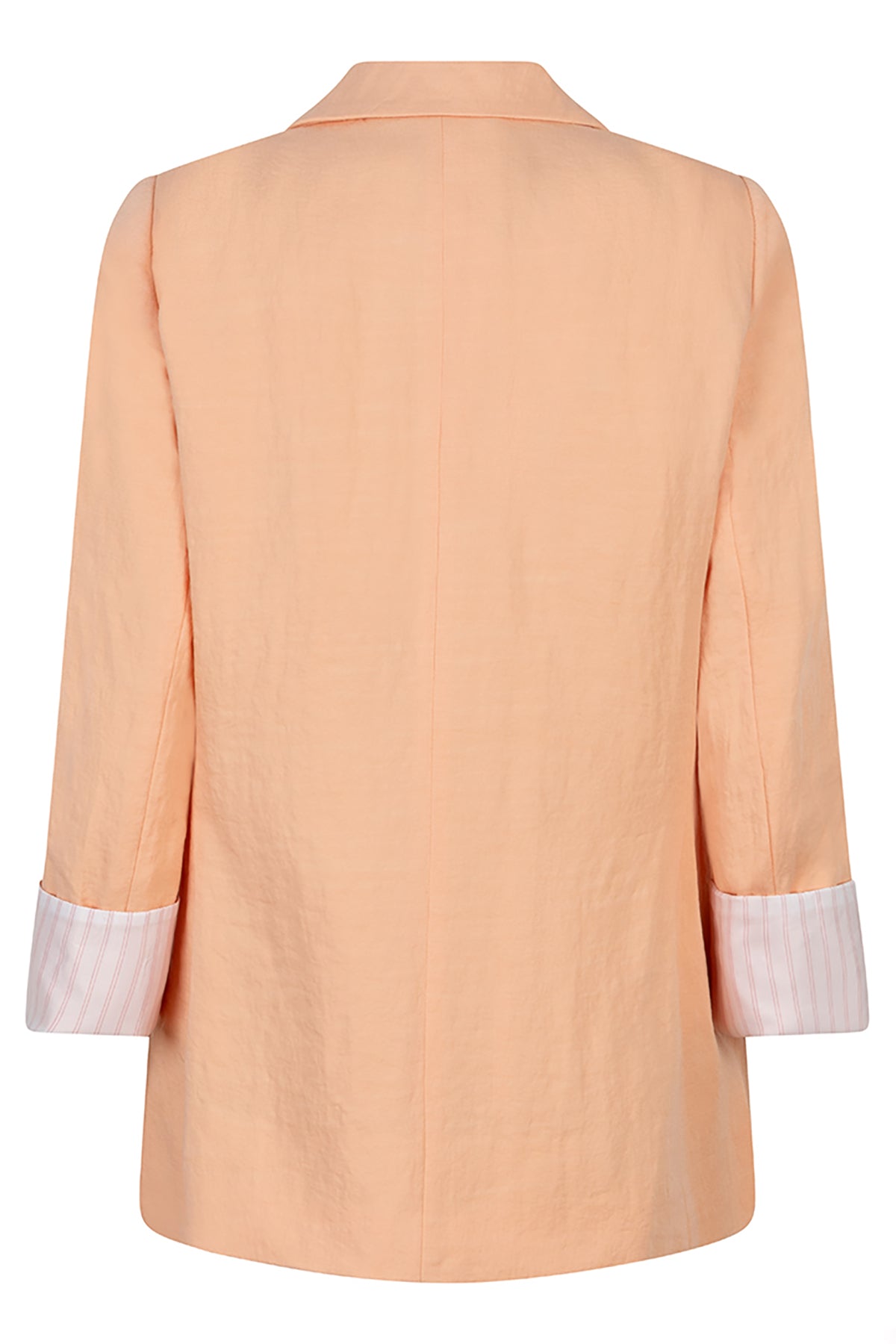 Light peach blazer with white cuffs on a white background