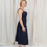 Indigo midi dress with a sweetheart neckline, corset-inspired seams, and a belted waist