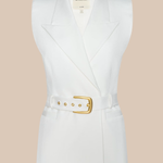 White sleeveless blazer with a gold belt on a beige background