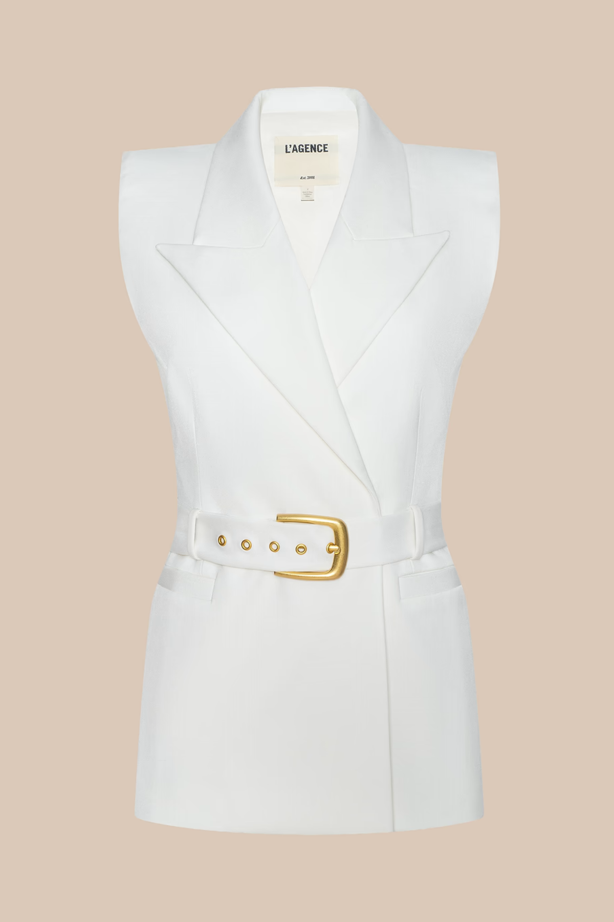 White sleeveless blazer with a gold belt on a beige background