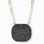 Necklace with black pendant and gold chain on a white background