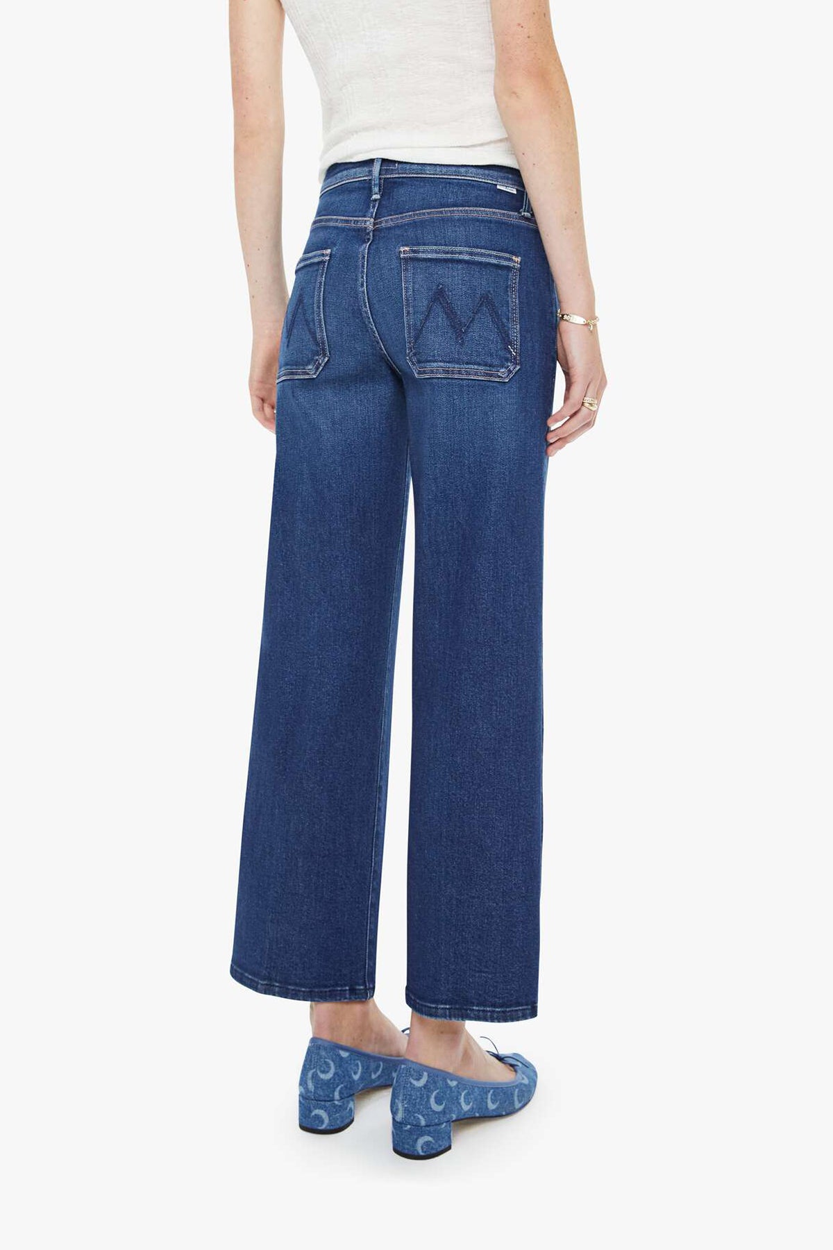 Person wearing blue jeans on a white background