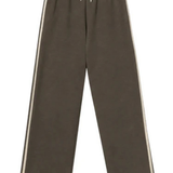 A pair of wide-leg jogger pants in dark brown, featuring double vertical stripes in beige on the sides and a beige drawstring at the elastic waistband, shown against a plain white background.