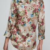 Floral patterned shirt worn by a person on a plain background