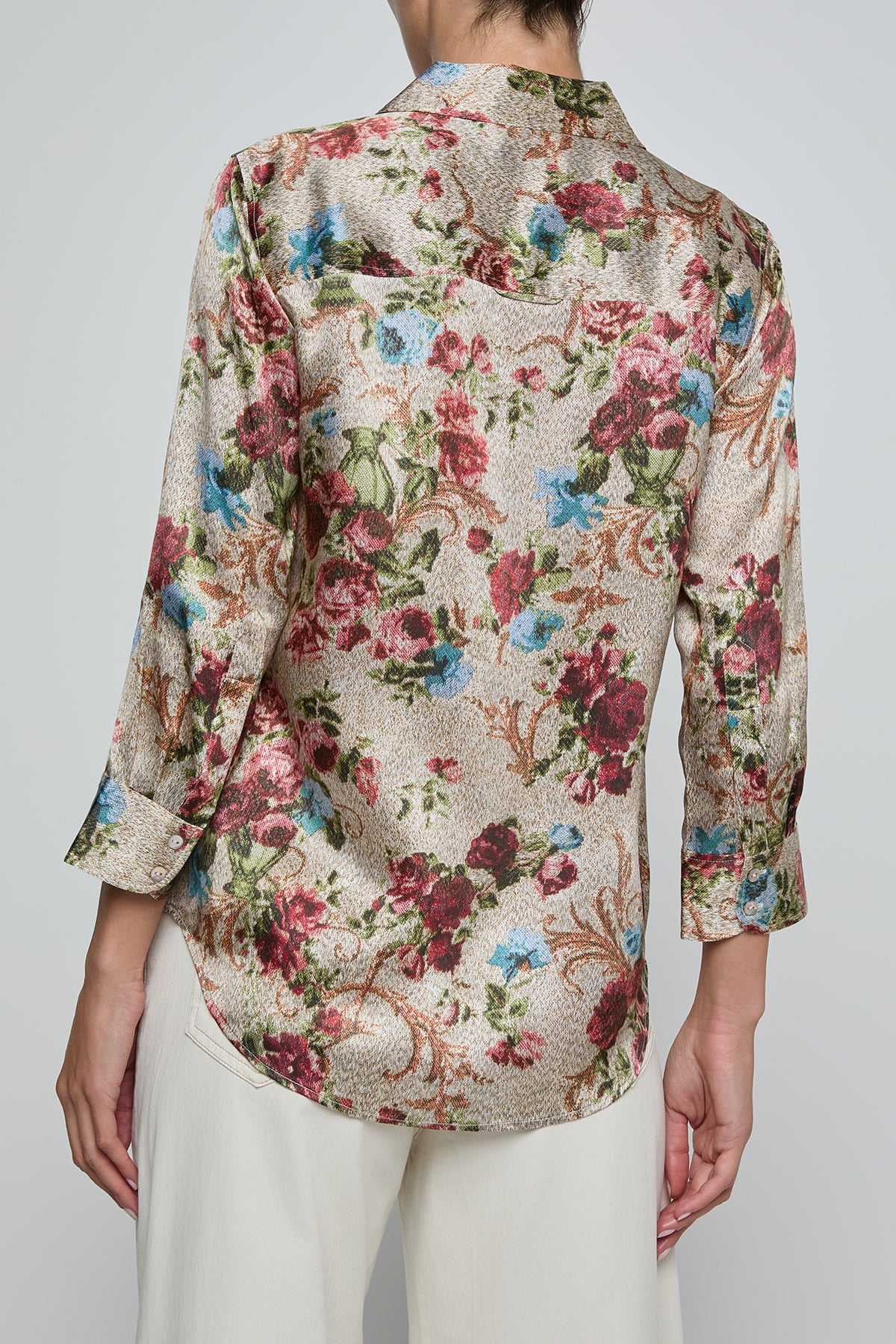 Floral patterned shirt worn by a person on a plain background