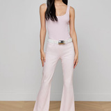 woman in pink top and jeans inside 