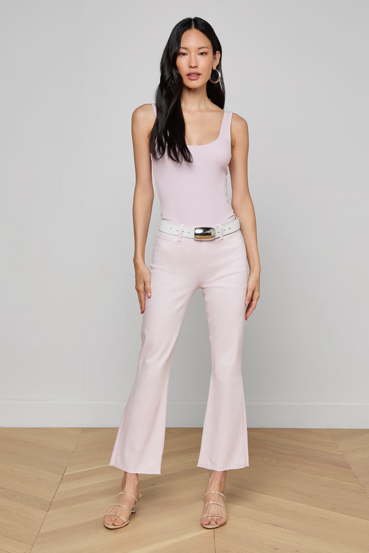 woman in pink top and jeans inside 