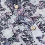 Close-up of a shirt with butterfly pattern and gold buttons
