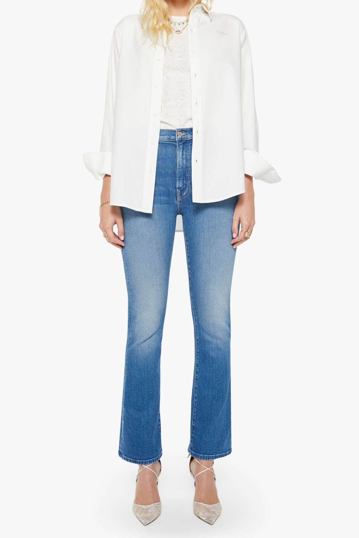 woman in white button down and blue denim on white background 