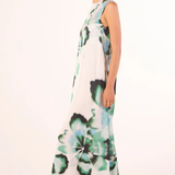 side view of woman in floral printed dress on white background 
